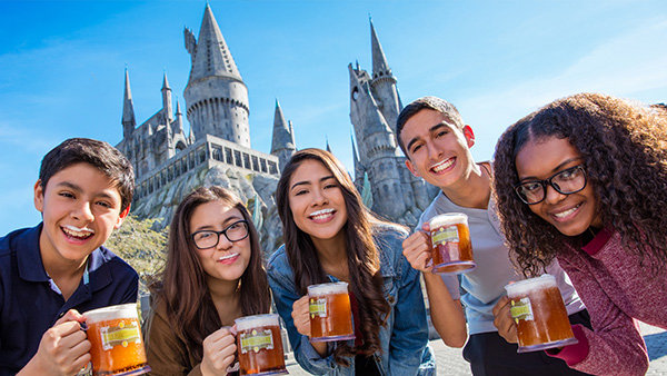 group of friends drinking butterbeer with white foam mustaches